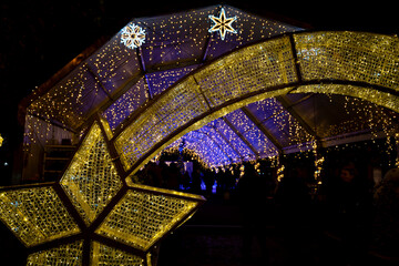 Illuminated holiday market in Pamplona, Navarra showcasing festive decorations and lights during...
