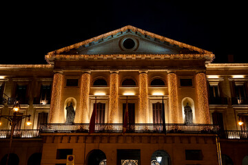 Stunning illuminated architecture of the Ayuntamiento in Pamplona at night showcasing vibrant...