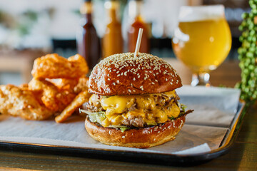 double smash burger with American cheese on a toasted sesame bun