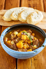 Tuscan beef stew with pumpkin and butternut squash served with sliced bread