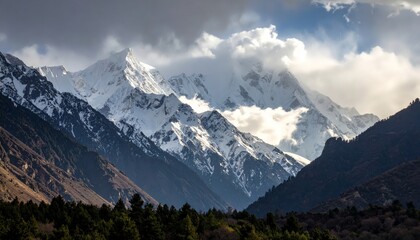 Snowy peaks shrouded by clouds in winter