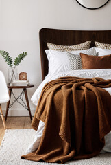 Cozy fall bedroom with curved walnut headboard, burnt orange wool blanket, and Eames-style bed