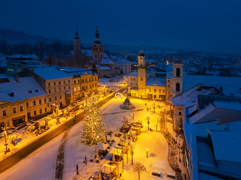 Aerial view of a snow-dusted N&Atilde;&iexcl;mestie SNP square, illuminated by the warm glow of streetlights and a festive Christmas tree, Bansk&Atilde;&iexcl; Bystrica, Banskobystrick&Atilde;&frac12; kraj, Slovakia.