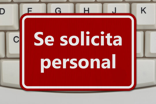Help Wanted Se solicita personal red sign on a computer keyboard