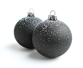 Two dark gray Christmas ornaments, speckled with faux snow, on a plain white background.