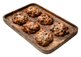 Homemade oatmeal cookies with nuts and dried fruits on wooden tray isolated on transparent background