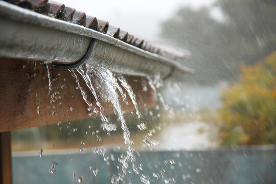 Leaking roof gutter during heavy rainstorm