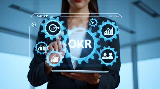 Businesswoman Interfaces with Digital Gears Displaying Okr Objectives in Modern Office with Window Light and Futuristic Technological Theme