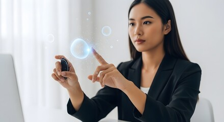 Asian businesswoman interacts with holographic interface, touching virtual spheres.