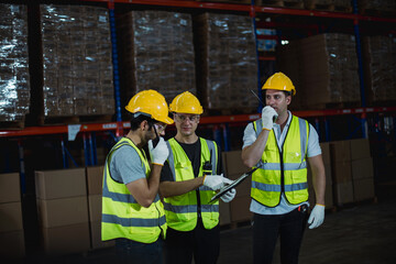 Logistics team working efficiently to load cargo at shipping warehouse, showing teamwork and industrial workflow.