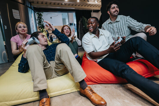 A diverse group of coworkers engaging in a video game session during a break, showcasing teamwork, friendship, and a casual office culture.