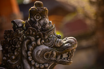 Old sculpture fully covered with green moss in Bali, Indonesia