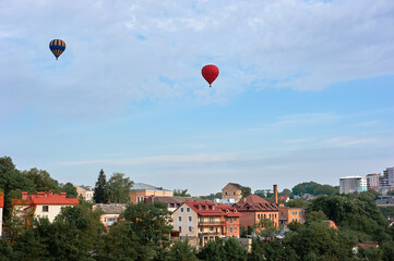 Hot Air Balloons Above a Scenic Urban Landscape with Vintage Architecture
