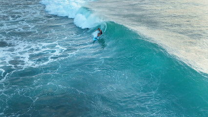 Surfer at the top of the wave in the ocean, top view, Bali, Indonesia