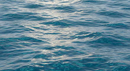 Fototapeta premium Close-up view of the ocean surface, showing gentle waves and sunlight reflecting on the water.