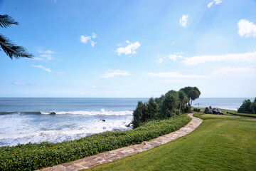 Scenic Coastal View with Green Lawn and Blue Ocean Waters