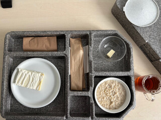 Hospital food on a hospital tray. Different dishes are arranged in the tray compartments. High-Angle Shot.