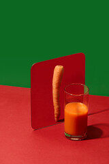 Carrot juice appears as whole carrot in mirror, showing aspiration. Concept of health,...