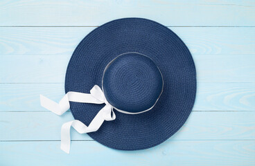 Blue beach hat on wooden background,top view