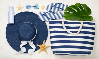 Blue beach accessories on concrete background, top view. Flat lay