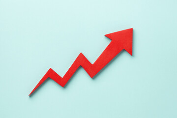 A red upward arrow on a light blue background, symbolizing growth or rising trends in finance or...