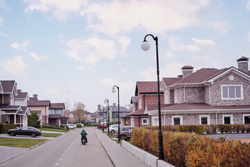 Quiet Suburban Street with Houses and Vehicle Under Clear Sky