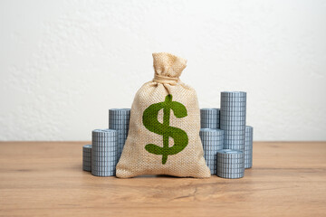Dollar money bag and stacks of coins. Wealth management, national or corporate surplus, and...