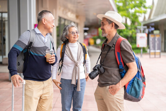 Happy senior tourists talking together, enjoy retirement with friendship and active aging, positive travel experience, elder wellness, senior travel tour, retirement life insurance and healthy living - Powered by Adobe