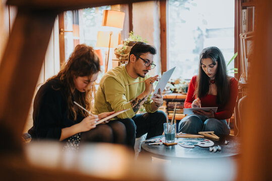 Group of friends collaborates on creative painting and drawing projects in a cozy, light-filled art studio setting. The scene emphasizes camaraderie, creativity, and artistic expression among people. - Powered by Adobe