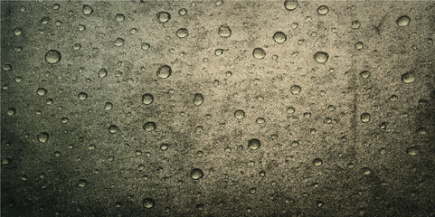 Wet rain droplets on a clear glass window create a blue abstract pattern