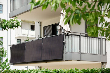 Solar Panels on Balcony Railing of Apartment Building. Modern Balcony with Small Solar Photovoltaic...