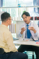 Fototapeta premium Doctor explains how to use dentures to patient. Dentistry concept. Dentist demonstrates and explains dental treatment to patient using denture model in dental clinic.