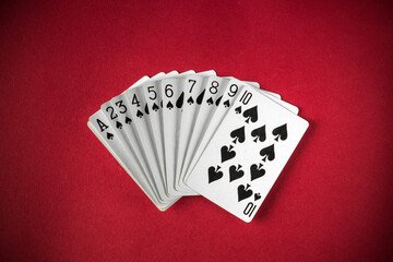 A set of playing cards featuring the spade suit is neatly arranged in ascending order on a vibrant...