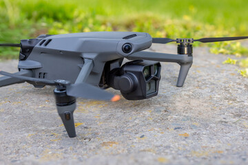 Drone on flat concrete surface with green grass in the background