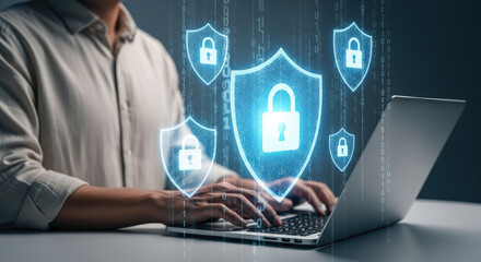 Cybersecurity Professional Working on Laptop with Digital Shield and Padlock Overlay for Data Protection and Online Security Solutions Concept