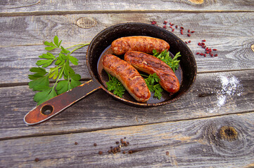 juicy sausages fried in a pan, top view