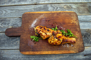 Grilled chicken legs, served with herbs  and solt