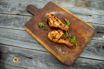 Grilled chicken legs, served with herbs