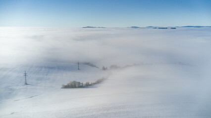 View of the snowy landscape of the Krkonoše Mountains during an inversion