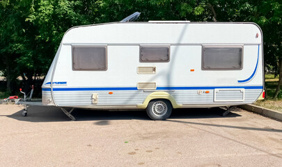 old white mobile home in a parking lot