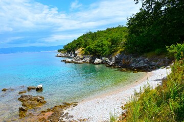 Beach with a forest above at the coast of the Adriatic sea at Krk in Croatia
