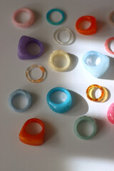 Collection of colorful plastic rings on white background. Selective focus.