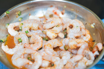 Cooking scampi in a pan.Fresh scampi being cooked in a pan. Close-up of sizzling seafood during preparation. Culinary concept with shrimp,lightly fried shrimp in a steel pan