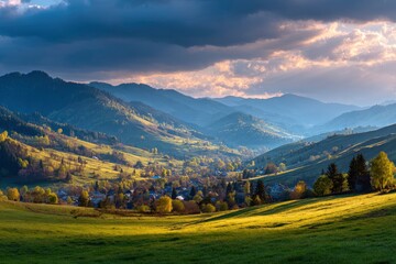 Obraz premium Valley landscape with rolling hills and a village light shining through clouds