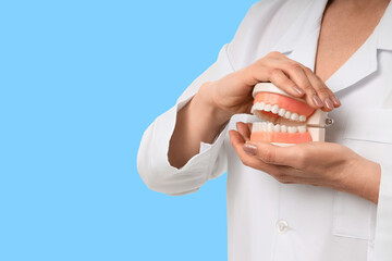 Practitioner showcases dentures while explaining dental care