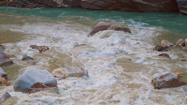 Slow motion shot of confluence of Spiti river and Sutlej river at Khab Sangam near Khab village in Kinnaur, Himachal Pradesh, India. Beautiful scenic view of two rivers merging in the Himalayas.