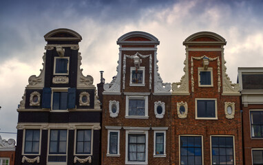 Ornate gables of historic dutch houses standing in amsterdam, netherlands, showing traditional...