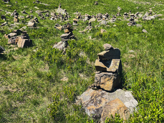 Scenic landscape with stacked stone cairns on a grassy hillside