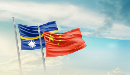 Nauru and China flags waving in beautiful sky. Two country flag for agreement or deal. Nauru China...