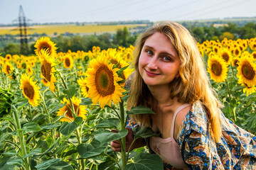 blonde woman in field of yellow sunflowers, portrait, looking into lens, smiling, teenager, bright...